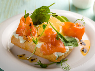 eggs Benedict with salmon and spinach macro close up