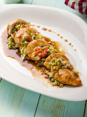Chicken filet steamed with vegetables on white plate