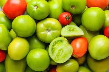 Green and ripe tomatoes as background, closeup
