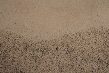 Fototapeta na wymiar Abstract Texture Rich photo of sand on beach going from smooth to rough