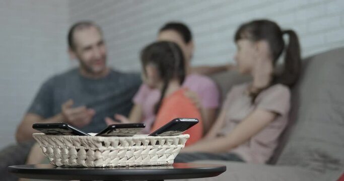 Family free from technology. Parents speak with their children and pas free time with no smart devices in the room.