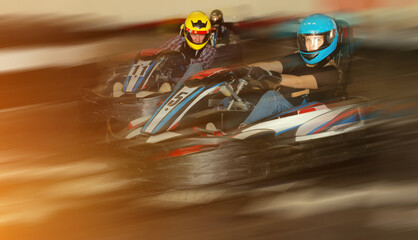 Young people driving sport cars for karting in a circuit lap in sport club © JackF