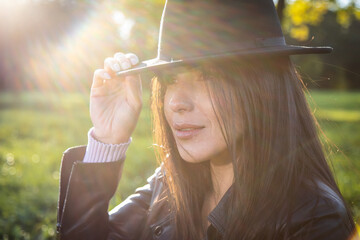 brunette girl in the park on a sunny autumn day
