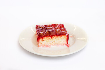 Blueberry trileche, in a round plate, cut into squares, milk dessert, close-up