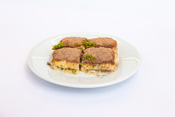 Traditional cold Turkish baklava with pistachio in milk