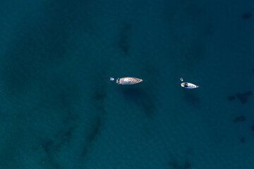 Aerial shot of moored sailing boats on sea of Valtos beach at Parga Greece