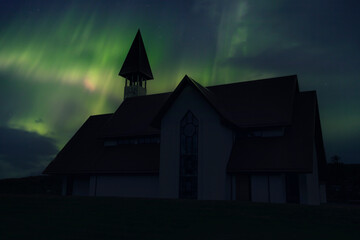 A beautiful traditional church near Reykjavik city one night with a beautiful Northern Lights. Iceland