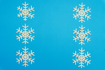 The Christmas composition, a group of white shiny snowflakes on a blue background, copy space....