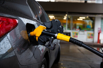 Refueling automobile with gasoline or diesel with a fuel dispenser and pay price with tax in gas...