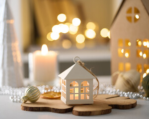 Cozy winter atmosphere. Candles, garland, beads. Christmas decor. Family seasonal wintertime...