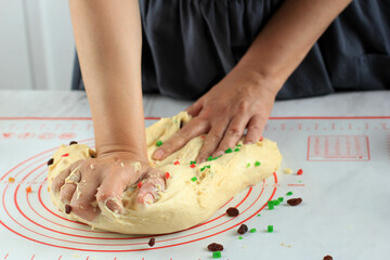 Female Home Baker Kneading Bread Dough with raisin and Dry Fruit, Process Making Christmast Stollen German Traditional Bread