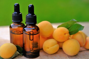 Apricot kernel oil. Organic oil. Apricot oil in a glass bottle with a pipette and ripe apricots fruits. natural Apricot oil