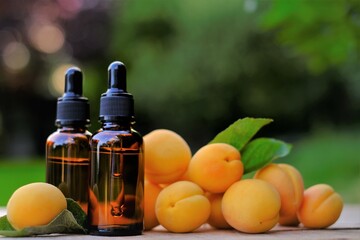 Apricot kernel oil. Organic natural oil. Apricot oil in a glass bottle with a pipette and apricots fruits. natural Apricot oil