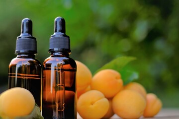 Apricot kernel oil. Organic natural oil. Apricot oil in a glass bottle and ripe apricots fruits. natural Apricot oil