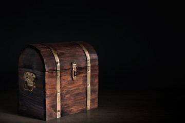 Wooden treasure chest on dark background