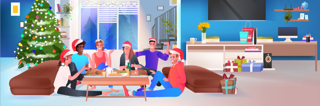 mix race friends in santa hats having christmas dinner new year winter holidays celebration concept