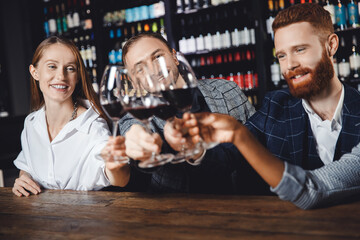 Happy multicultural people with glass of red wine at meeting party restaurant
