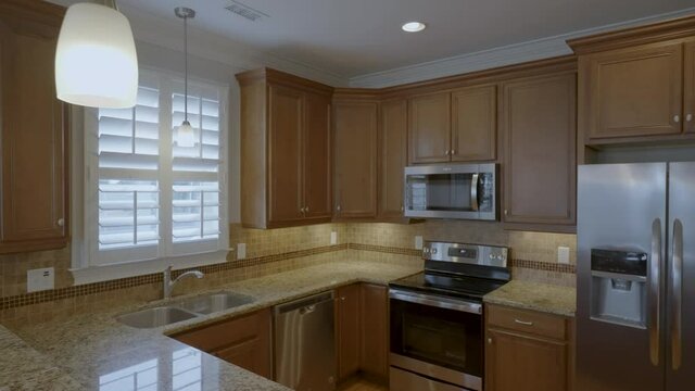 Interior clean open plan kitchen gimbal shot track in 