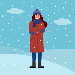 Happy woman wearing winter coat, gloves and scarf in falling snow on background. Winter season celebration.