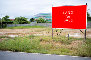 A sign advertising agricultural land for industrial use for sale.