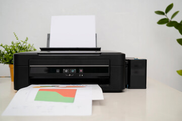 black printer in office with soft-focus