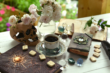 Vintage summer still life with runes, old book, crystals and witch magic objects.