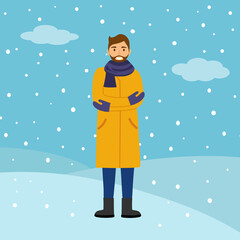 Happy man wearing winter coat, gloves and scarf in falling snow on background. Winter season celebration.
