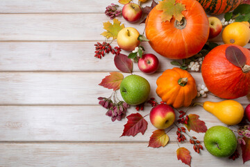 Fall centerpiece with pumpkins, orange squash, leaves, copy space
