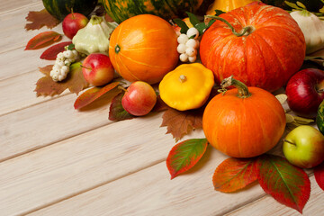 Fall arrangement with orange pumpkins, snowberry, yellow squashes, copy space