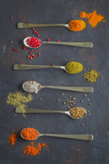 Multicolored spices on a blue background. Top view.