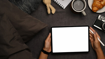 Woman hands holding mock up digital tablet with blank screen.