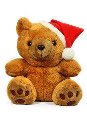 Soft toy bear in a Christmas hat on a white background.