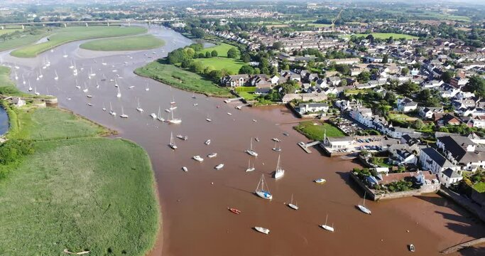 Sailboat Anchored In River Exe In Tophsam On Sunny Day. Aerial Dolly Forward