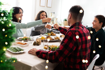 Happy caucasian family toast together with champagne to celebrate Christmas at home.