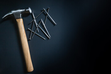 hammer and nails on black background