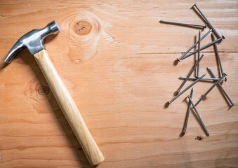 hammer and nails on wooden background