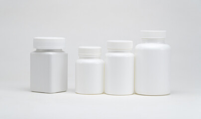 White plastic pill jars on a white background. Isolated