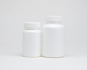 White plastic pill jars on a white background. Isolated