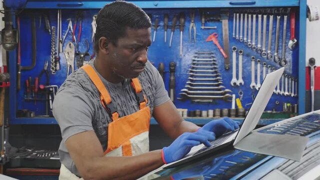 Automobile computer diagnosis. Car mechanic repairer looks for engine failure