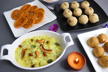 Indian festival food - Diwali Special sweet and salty snacks such as Chakli, Rava laddu, besan ladu, poha chivda, and corn mixture, Namkeen snacks. Diwali Faral from Maharashtra, India. Copy space.