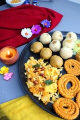Obraz na płótnie Canvas Indian festival food - Diwali Special sweet and salty snacks such as Chakli, Rava laddu, besan ladu, poha chivda, and corn mixture, Namkeen snacks. Diwali Faral from Maharashtra, India. Copy space.