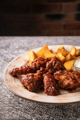selective focus. barbecue chicken wings in breaded and sweet sauce. with natural sauce. restaurant serving. on a dark background. for menus and ads