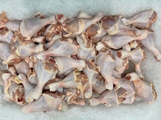 Fresh chicken drumstick at a supermarket, selective focusing