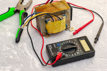 electric transformer pliers and ampervoltmeter on the table surface