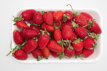 Fresh strawberries in a plastic container from the supermarket