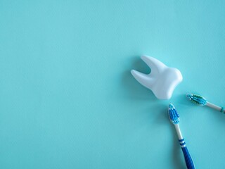 Teeth and toothbrush on a blue background.