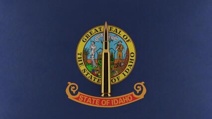 3D rendering of top down view of a single rifle bullet in the center and on top of the US state flag of Idaho