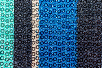 fabric texture with colored stripes sewn on with sequins