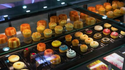 Cream donuts and cupcakes in the bakery shop.