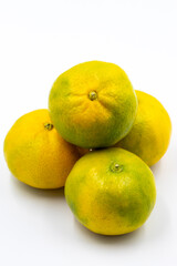 Tangerines on a white background. In combination with a shade of ripe sweet tangerine. Story format close-up